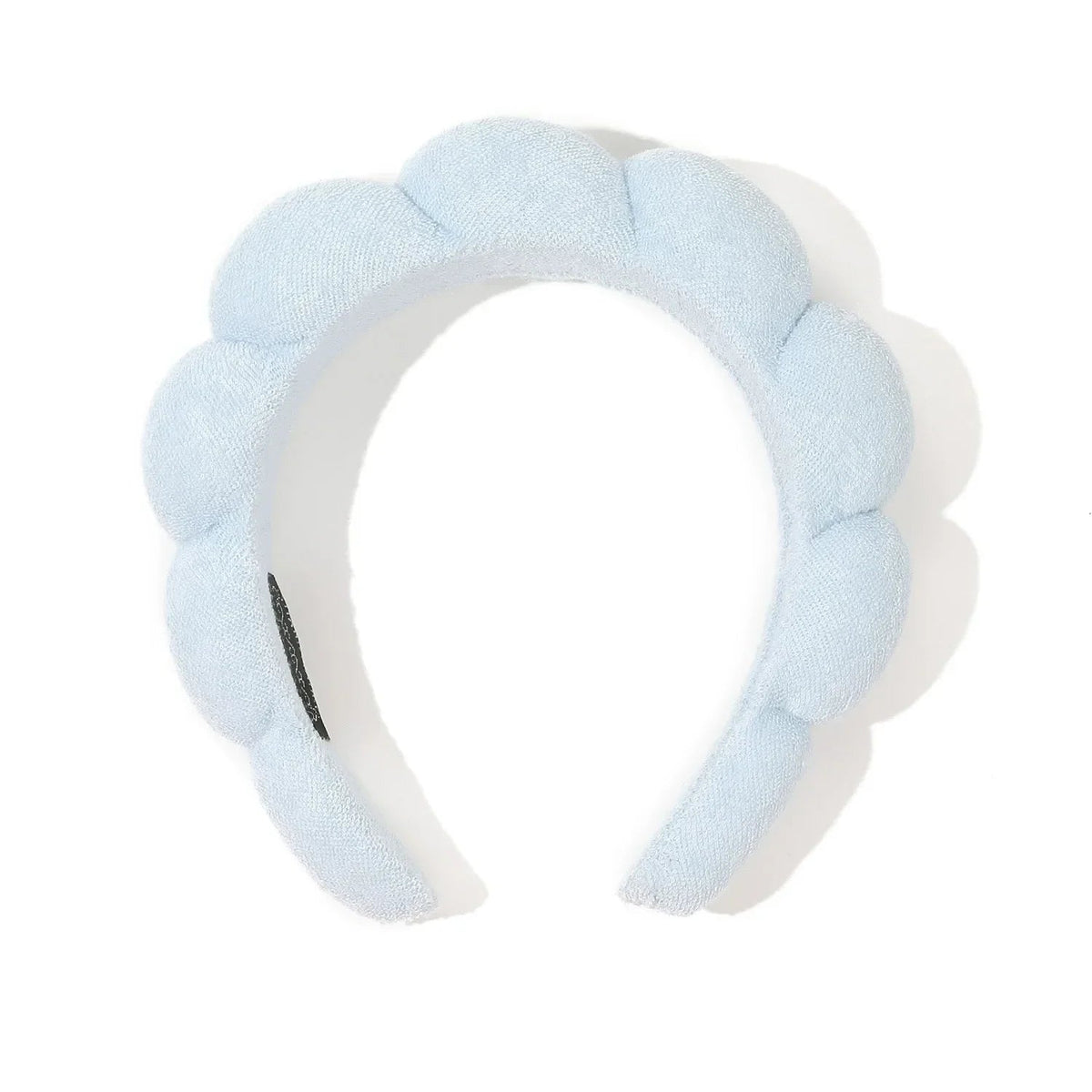 Light blue headband with a textured surface on a white background