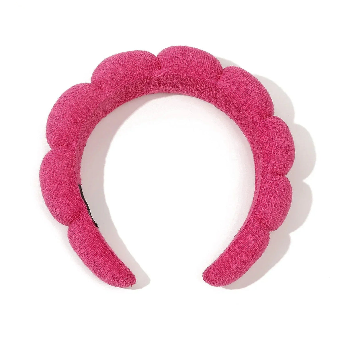 Pink headband with floral design on a white background